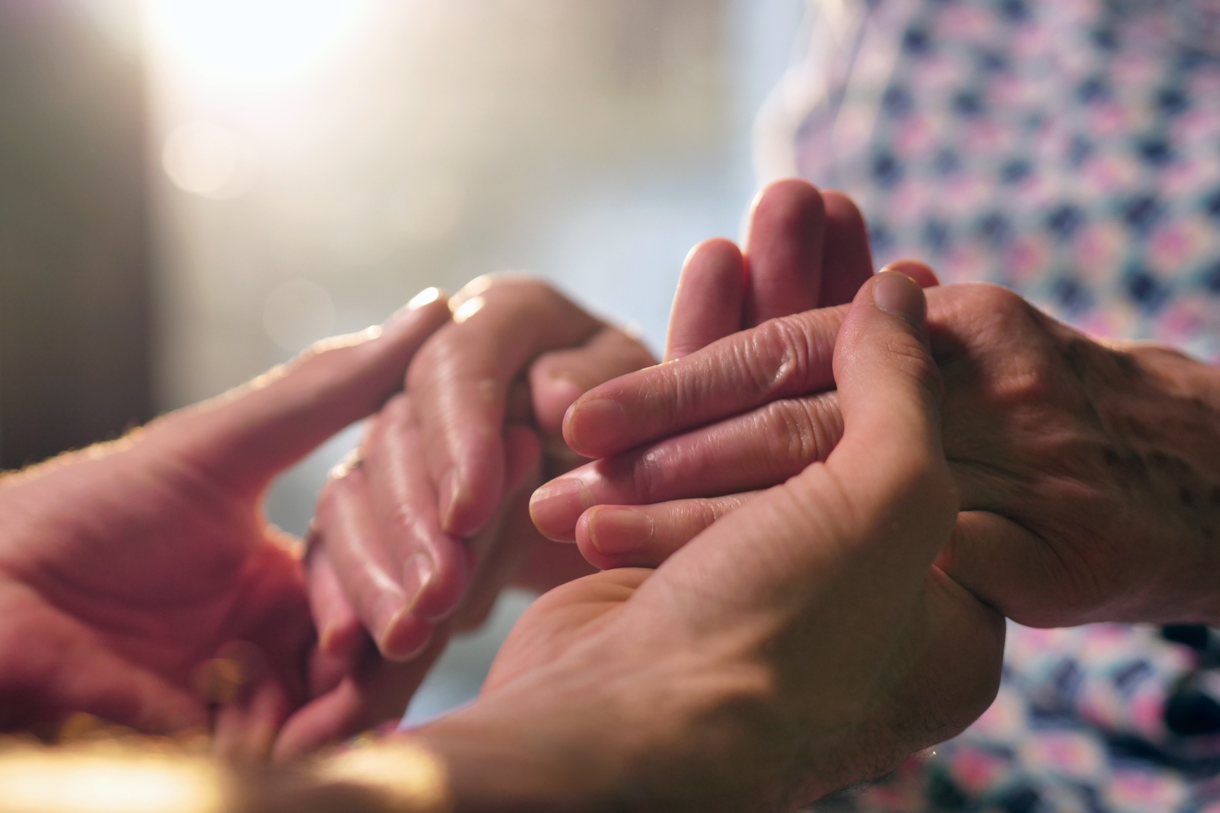 Image of two people holding hands.