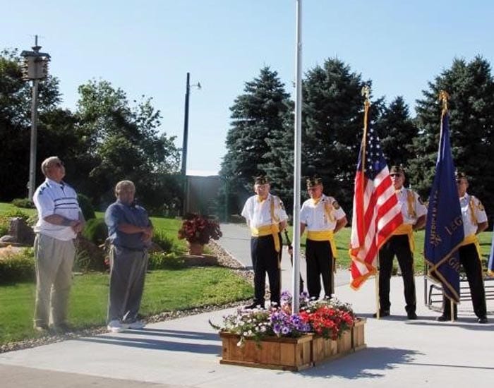 Image of some veterans honoring the flag.