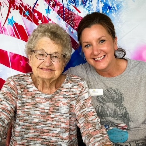 Image of a nurse sitting with a patient.